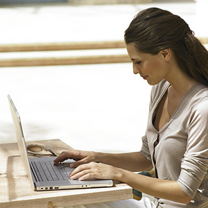 Woman with computer-books-author-features-woman and home