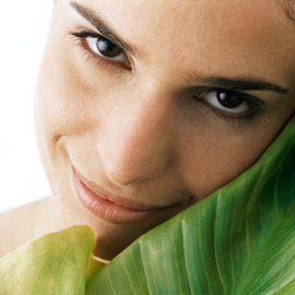 Woman smiling with leaf Woman smiling with leaf-Massage-beauty tips-skincare-anti ageing-body-relaxation-woman and home