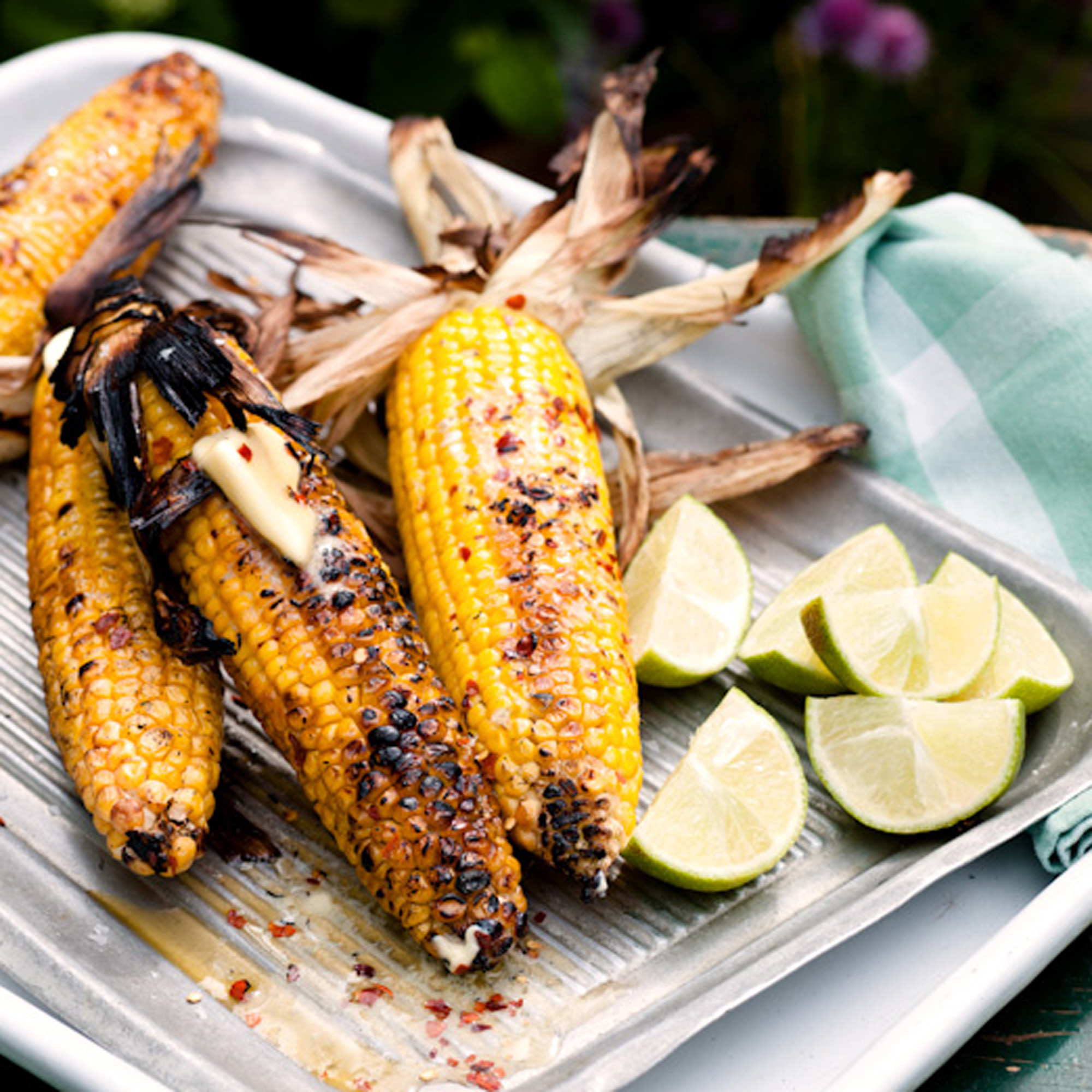 Barbecued corn in its husk with lime and chilli butter recipe Barbecued corn in its husk with lime and chilli butter recipe