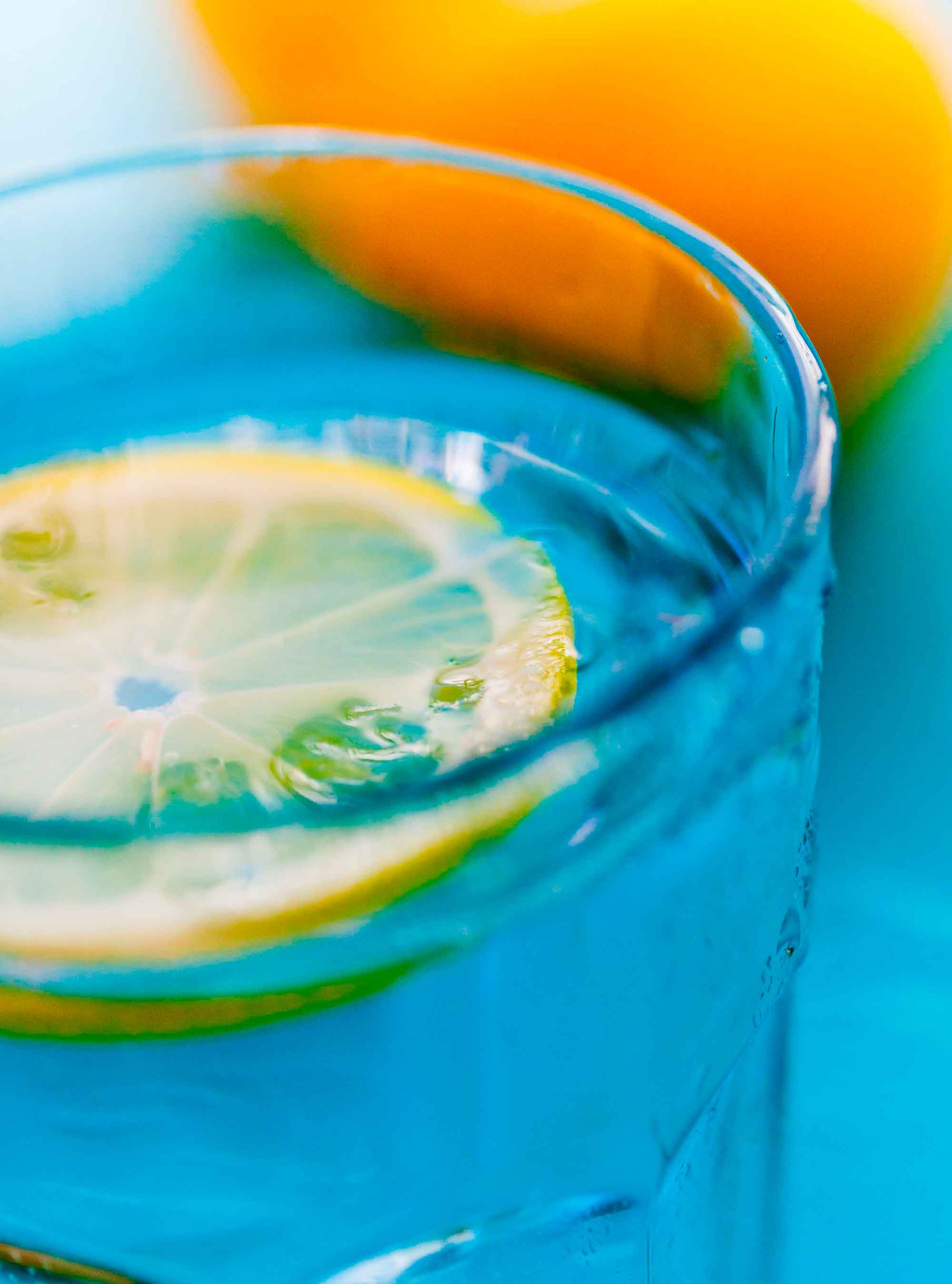 glass of water with lemon photo - ways to beat the bloat
