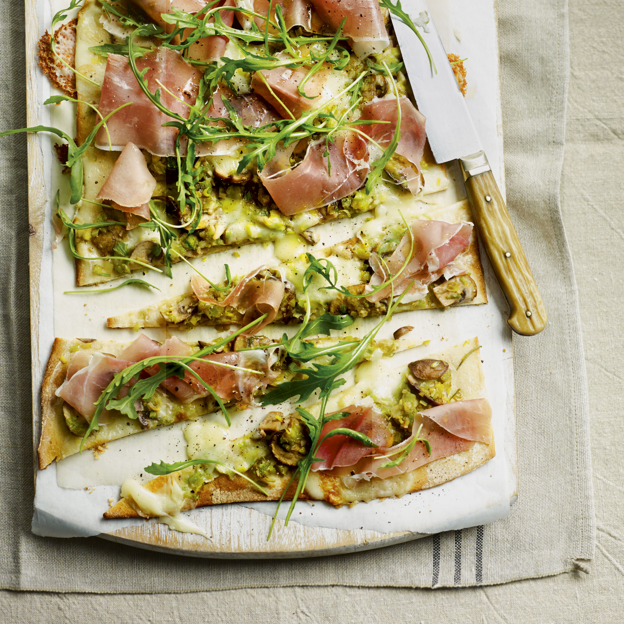 Cheat's leek, mushroom and taleggio pizza with sliced prosciutto